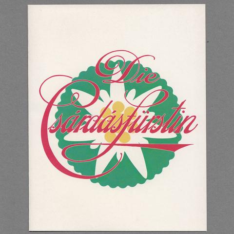 Off-white greeting card with the text "Die Csárdásfürstin" in red cursive font over a green circle with a stylized edelweiss flower in white and yellow. Grey cardboard in the background. Good-luck card for the premiere of the operetta Die Csárdásfürstin by Emmerich Kálmán in Detmold, Germany, seasons 2016–2018.