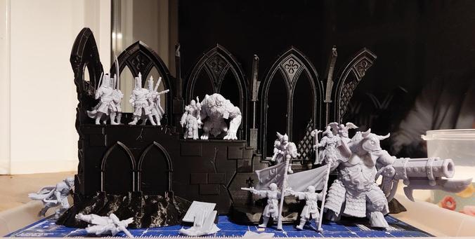 Partial gothic Cathedral ruined with all kinds of Awesome trench crusade sculpts around it, including a minotaur with a cannon with a bayonet, some relaxed looking Janissaries, some ugly mutant thing that might be a massive gorilla but it's called a lion of jabir, and some other stylish Warriors.