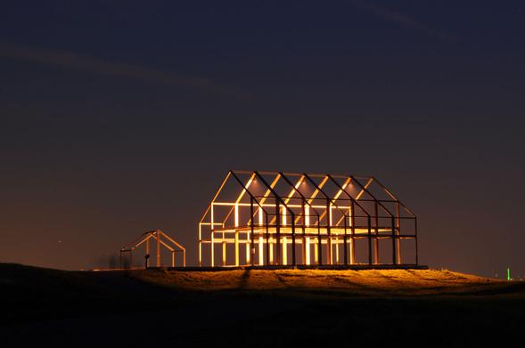 The "Hallenhaus", an art installation on the Halde Norddeutschland near Neukirchen-Vluyn in Germany glowing at night.