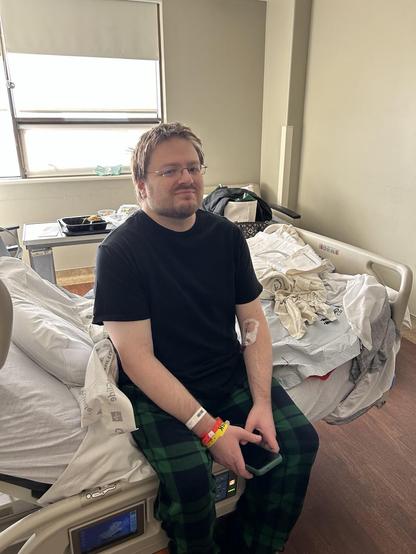 Me, back in street clothes, sitting on the hospital bed in my room shortly before discharge.