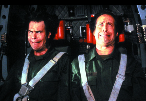 Two test subjects, buckled into a centrifuge, spinning so fast you can't make out their identities. Their faces are being smooshed due to extreme force.