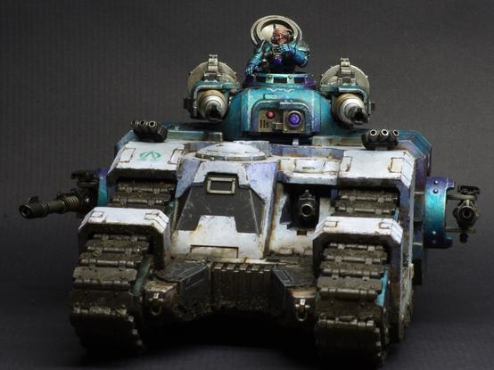 Front view of a sicaran battle tank from the horus heresy. Painted in the colours of the Alpha legion in white and metallic blue.