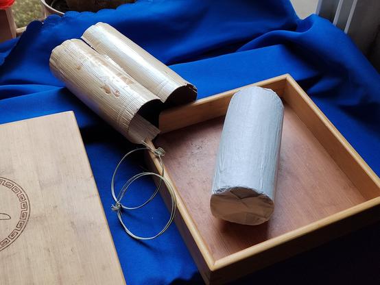 When you strip the leaf packaging you get a white cylinder.  In this case the white cylinder is in my bamboo tea tray used for storing and tearing apart pu'er teas.  Unfortunately this tray is for the 357g discs and this cylinder is 500g.  This will cause problems later.