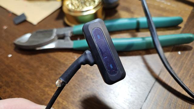 A USB-C wireless microphone receiver with a cable attached to it where the USB-C male plug used to be. The cable is roughly heat-shrinked on, a blob of hot-glue is squeezed out the end of the heat-shrink like an errant ballsack escapee from a pair of budgie-smugglers.