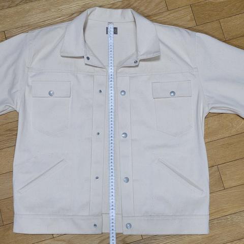 Off-white sateen jacket with a tape measure from the collar to the waistband