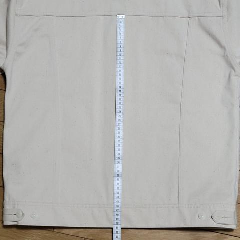 Off-white sateen jacket with a tape measure from the back yoke to the waistband