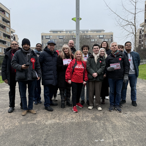 A row of Councillors and members lined up for a photo, some holding Labour leaflets