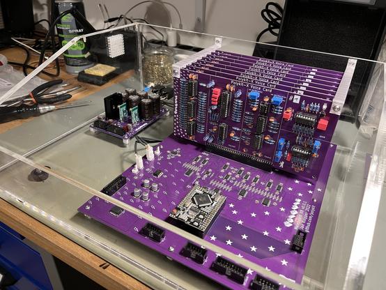 Half finished polysynth in the acrylic casing. Jacks, PSU and main board with voice cards are in.