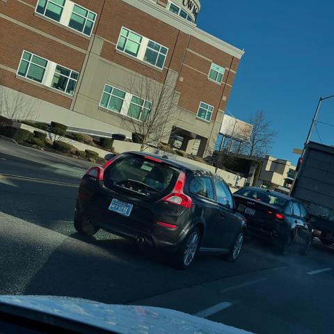 A black facelift Volvo C30 from behind on a street in North Seattle.