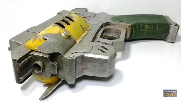 The Outer Worlds pistol prop replica laying on it's side.