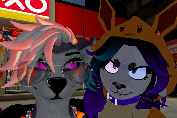 The image depicts two anthropomorphic characters, likely from a video game or virtual world. The character on the left appears more relaxed, while the one on the right has a more aggressive expression with narrowed eyes. They seem to be posing for a selfie, suggesting a playful interaction despite the contrasting expressions.