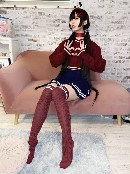 Hima on a half couch making a heart sign