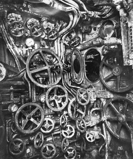 wildly organic submarine engine room full of wheels to turn & portal