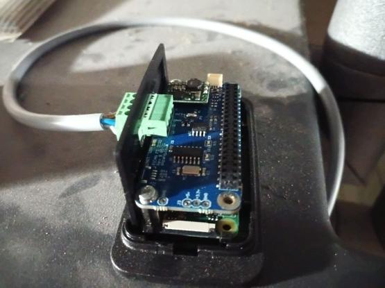Geöffneter RaspberryPi Zero 2W in dem modifizierten HifiBerry-Gehäuse. Zu erkennen ist darauf die PiCAN Zero platine mit dem modifizierten Spannungsversorgunsmodul darauf.