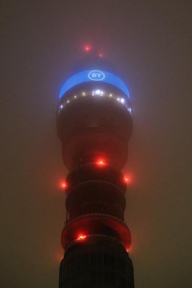 Red lights of BT tower in a heavy fog.