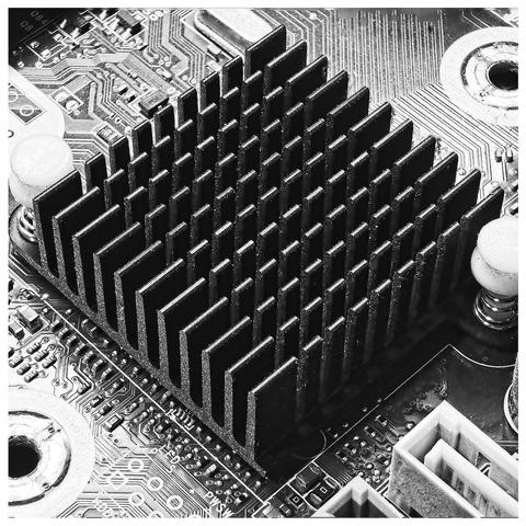 Heat fin in black and white in the centre of a circuit board.