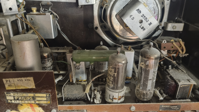 The inside of a 1950s AM radio. A closer view of the main circuit board. All four tubes are now visible.