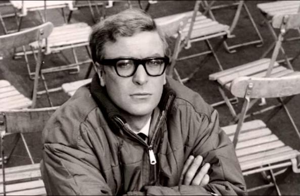 A black and white photograph of Michael Caine playing Harry Palmer in the “IPCRESS File”. 

source https://youtube.com/watch?v=AwVAxaXWMFw