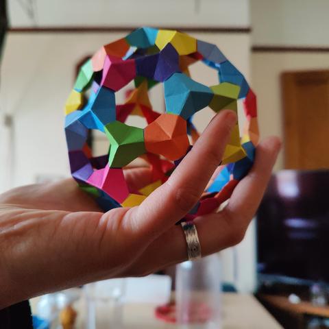 Sonny holds the polyhedron aloft.