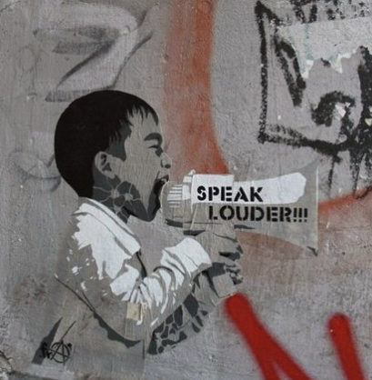A child depicted in a graffiti style is shouting into a megaphone, urging others to "SPEAK LOUDER!!!". The background features abstract markings and colors, contributing to a sense of urgency and expression.