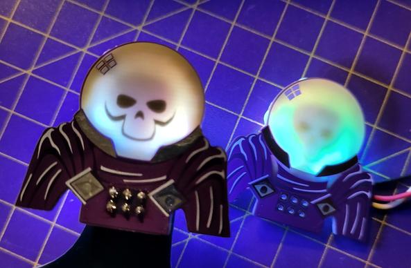 2 purple PCBs, shaped as a torso bust of mysterio. a skeleton skull is visible in the fog bowl helmet