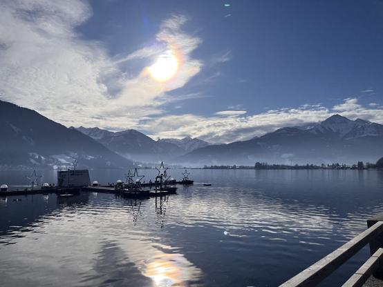 Sunny view over a lake in Zell am See, Austria. Snowy Mountains in the background.