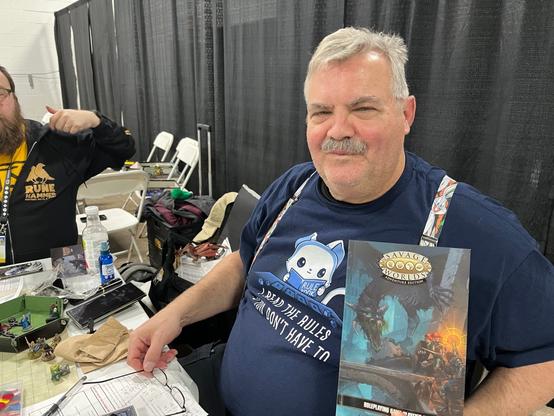 My EXCELLENT Savage Worlds GM posing with the SWADE Player’s Book he gifted me!