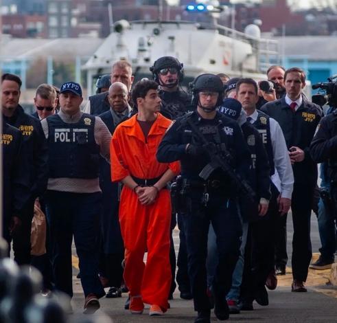 The Luigi Mangione perp walk that made him look like a superhero because he’s surrounded by dozens of various cops. The New York mayor who has been indicted for felonies is somewhere in there as well, with the cops of course.
