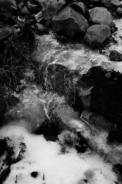 A black and white photo of ice formed when a shallow flow of water over stepped rocks has frozen. Torridon, Wester Ross, Scottish Highlands.

Photo by and copyright of Paul Henni.