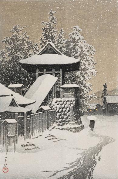 A lone figure walks past a quiet temple bell tower on a gloomy, snowy day. The figure carries a bamboo umbrella over their head as they trudge down a meandering track worn by foot traffic in the snow. Fresh snow covers the ground, the temple structures, and clogs the branches of tall trees standing just beyond the tower. Above, the sky is overcast with a dingy, grimy look; snow continues to fall across the scene. The image is rendered in sepia tones.