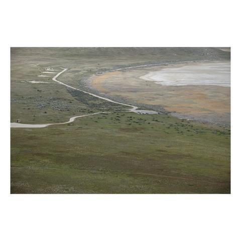 looking down on a large, empty campground with roads next to a dry bay.