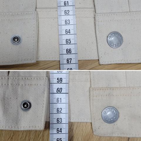 Two closeup photos of the waistband of the same jacket, the top one before the first soak and the bottom one after. A measure tape shows the difference in length due to shrinkage