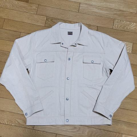 Front view of an off-white sateen jacket after a first soak