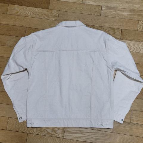 Back view of an off-white sateen jacket after a first soak