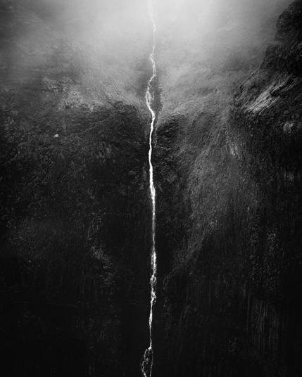Black and white landscape image, of a small stream falling through cliffs into darkness, and fog above the river
#Photography #LandscapePhotography #BlackAndWhite #Nikon #FineArt