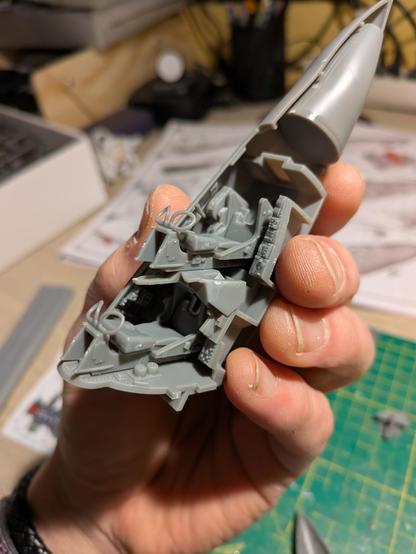 The partly assembled nose with cockpit of a plastic model kit of a Blackburn Buccaneer fighter bomber aircraft