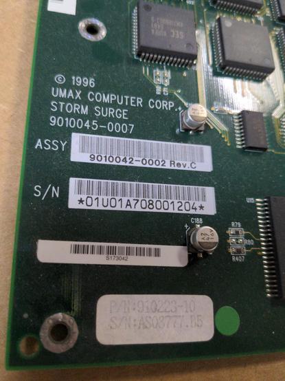 A closeup of the label screenprinted on the motherboard in white: © 1996 UMAX COMPUTER CORP. STORM SURGE 9010045-0007. Below that are barcodes and serial numbers.