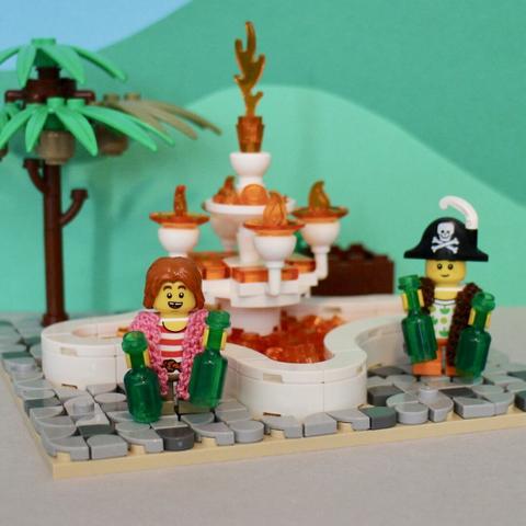 2 lego kid minifigures filling bottles of rum from the fountain of youth