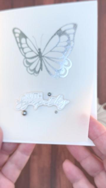 Still from vertical video of a minimalist sympathy card. It features a large butterfly and the greeting "With Sympathy."