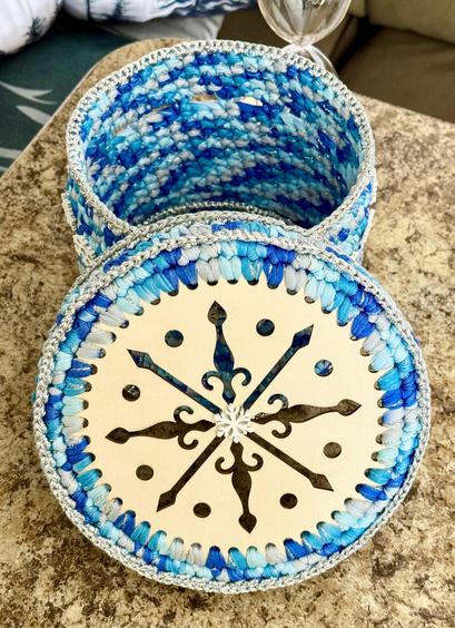 Snowflake Basket with wooden bottom and laser carved top! Multi blue colored t-shirt yarn, edged in silver bakers twine. White snowflake center on top.
