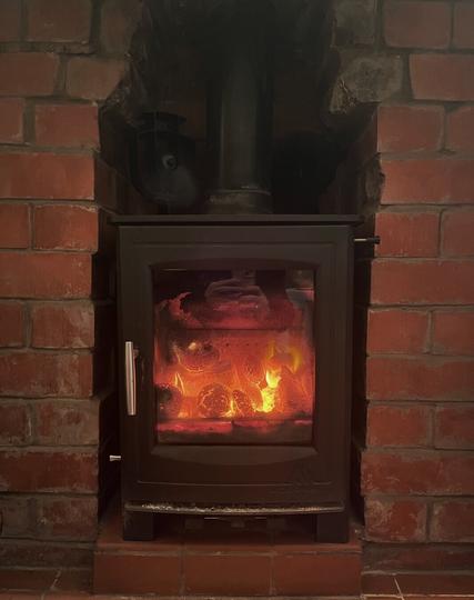 Picture of a stove in my house with coal embers burning. This makes me feel comfortable and relaxed.