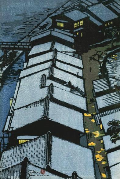 A view looking down into a residential street on a dim winter evening somewhere in Japan. On our left, a river curves up and across the top of the image; on the riverbank, a row of houses follows the line of the river, light shining in their windows. An uneven layer of snow covers the tile rootops of the houses. In the street on our right, hanging lanterns throw splashes of yellow illumination across the ground, and a few shadowy pedestrians walk along the road.