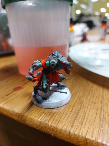 Student's werewolf for blood bowl. The thing is looking angry in itself and they've painted the skin in Gray, armour plates brown with cyan highlights, and cloth red.