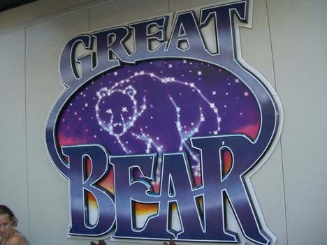 Photograph of the Great Bear rollercoaster sign from Hersheypark. The Text "Great Bear" is in blue and in the center of an oval is the drawing of the night sky with a bear drawn in as a constellation.