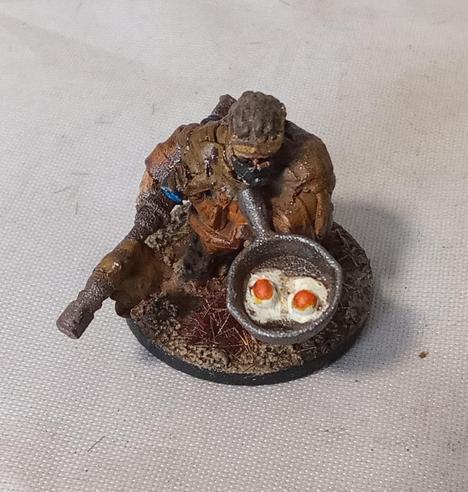 A close-up on the sniper with the frying pan, eggs taking pride of place.