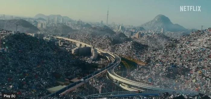 A cgi image of a city buried in plastic waste