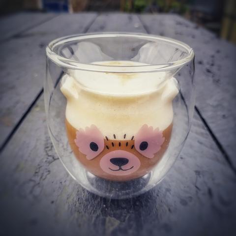 Thermal glass with a bear face, with a foamy coffee