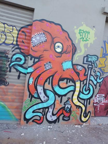 All these pictures are super colored graffiti in the facade of the same building. This one is an octopus.