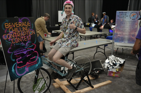 a smiling contest participant in DEF CON 32's Beverage Chilling Contraption Contest