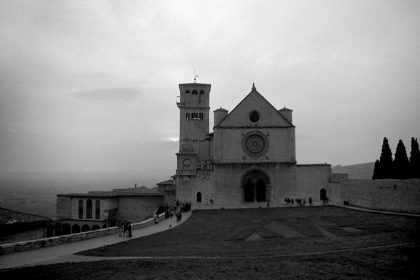 Black & white image of an imposing cathedral. In front, 'PAX' is mown into the grass.